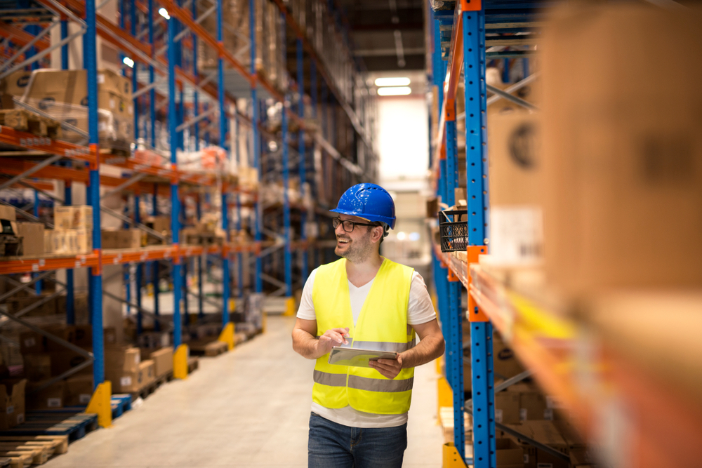 Warehouse,Worker,Holding,Tablet,And,Checking,Inventory,In,Large,Distribution